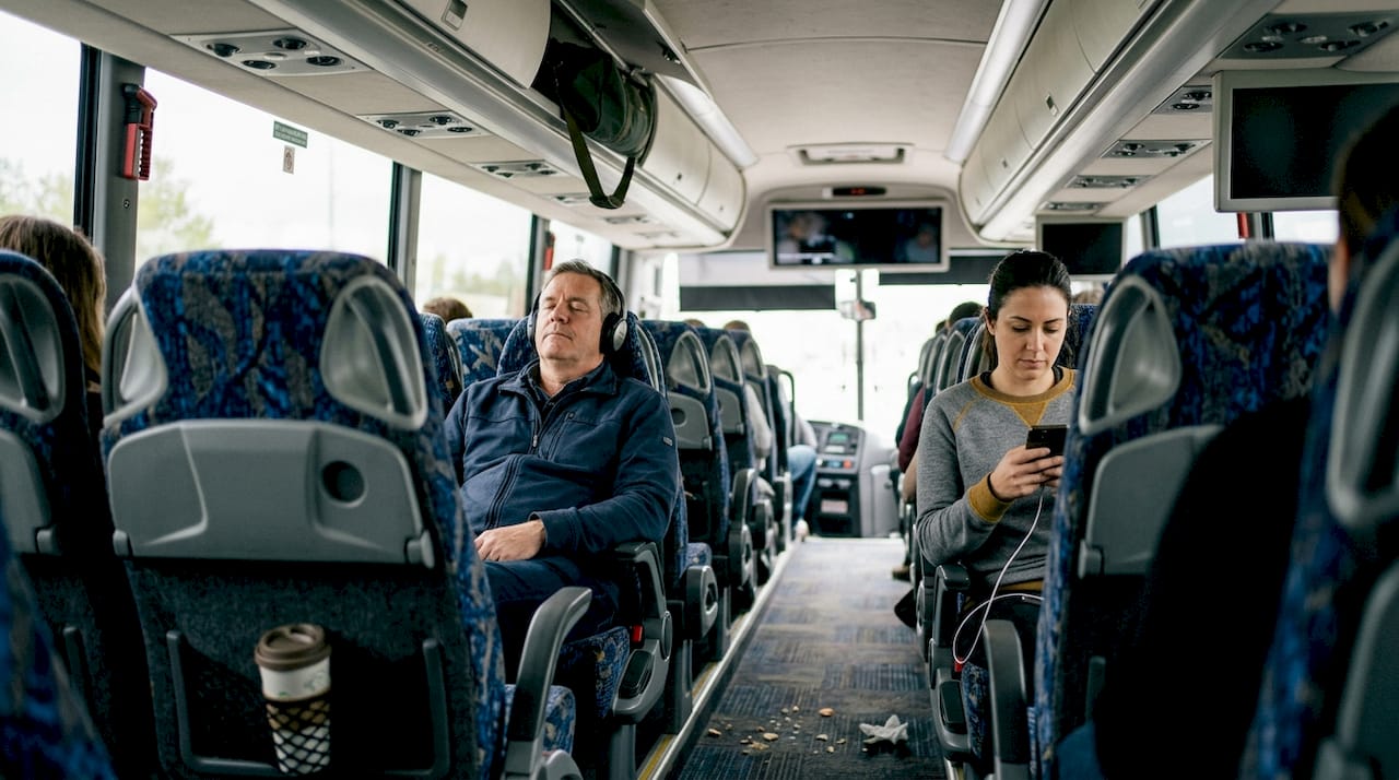 Motor coach interior with amenities and travelers