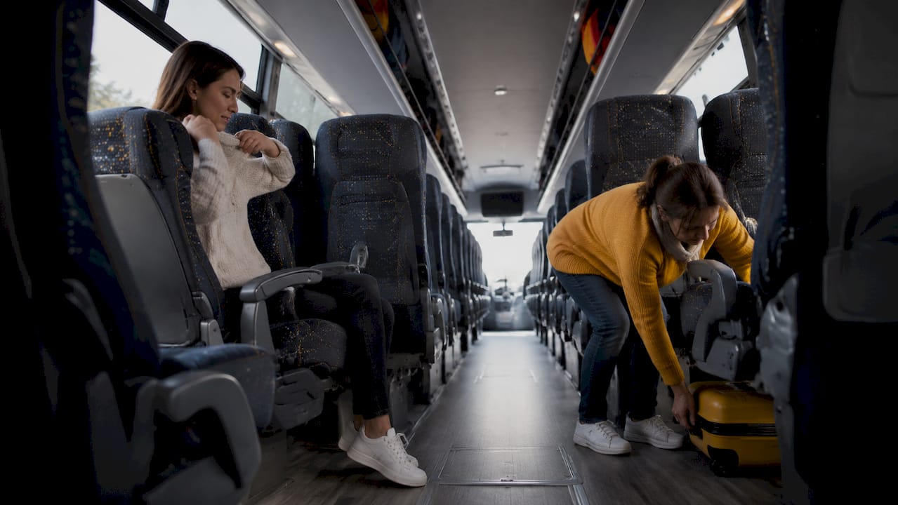 Interior view showing bus seat spacing and passenger comfort