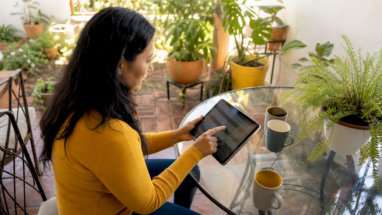 Hands pointing at tablet in booking meeting