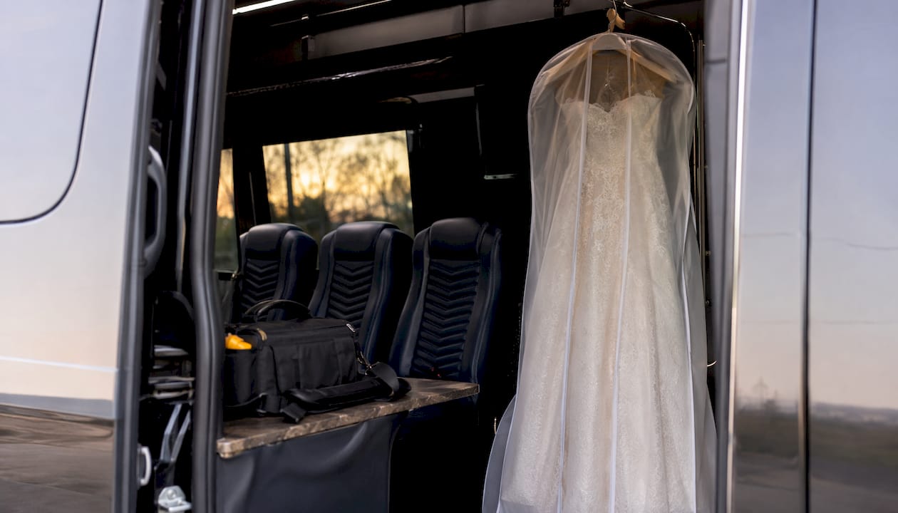 Wedding dress hanging inside minibus interior