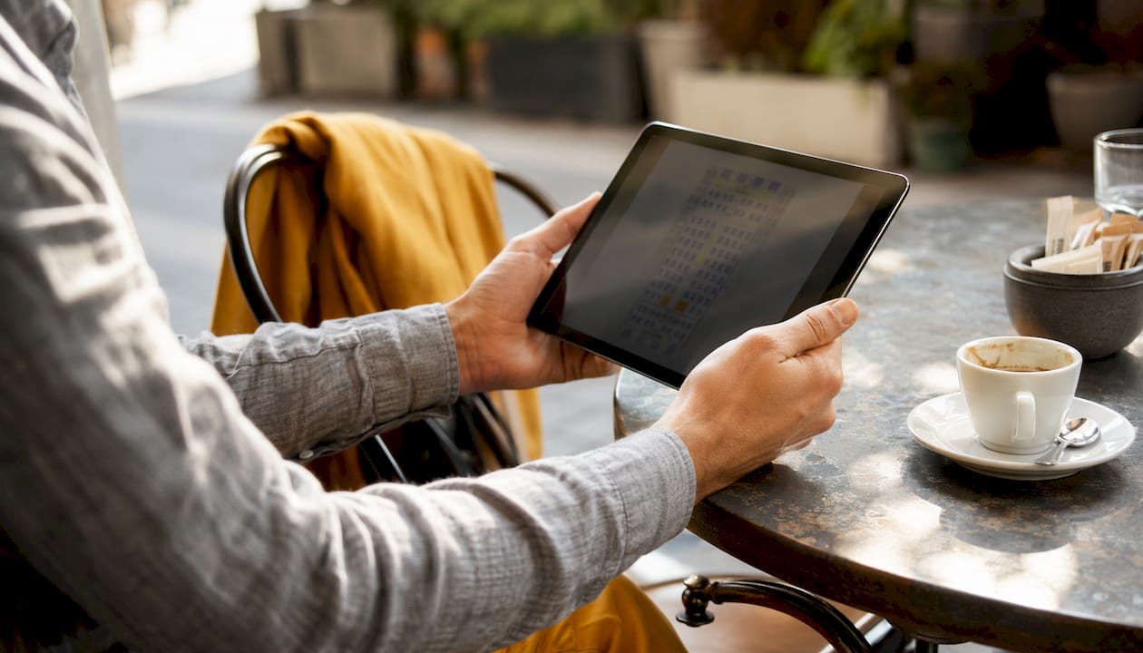 Hands holding tablet with transport seating chart