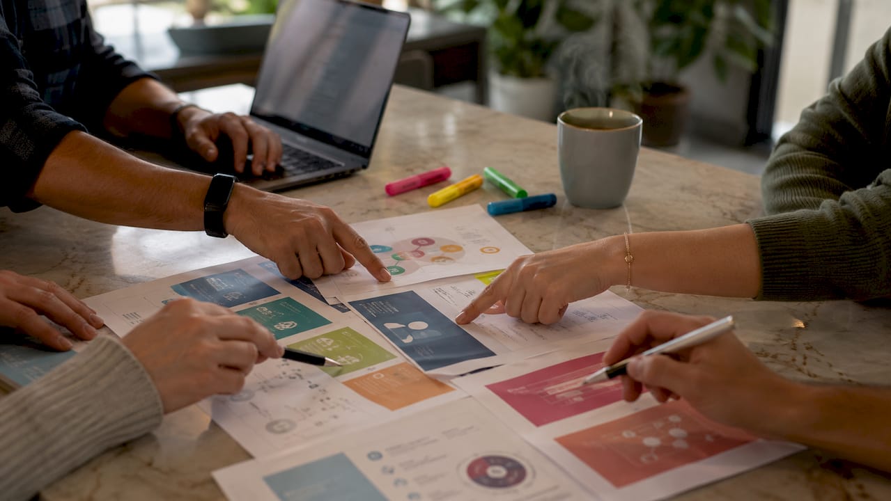 Hands discussing CRM types over printed documents
