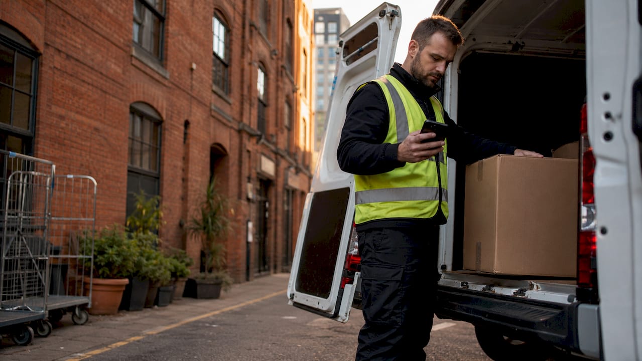 Courier preparing shipment outside warehouse