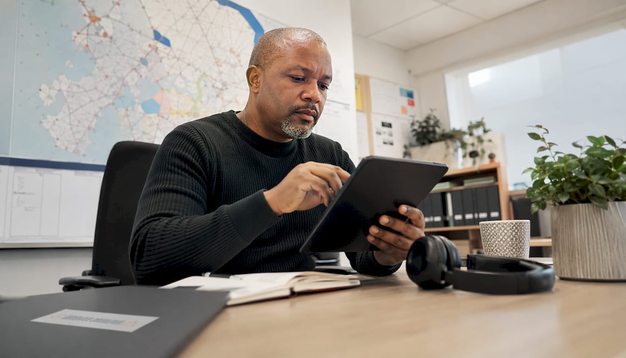 Man using courier logistics app on tablet