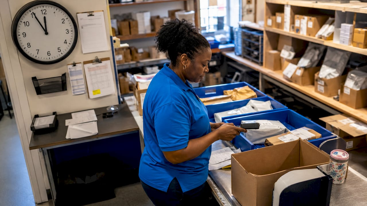 Courier sorting packages in Bournemouth warehouse