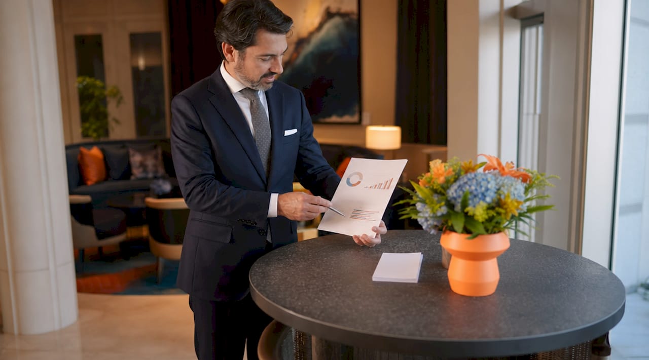 Hotel receptionist reviewing guest feedback