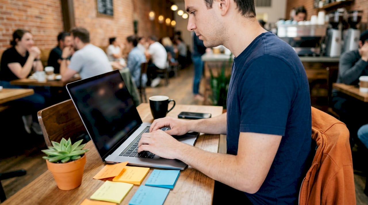 Close-up of hands typing code at desk