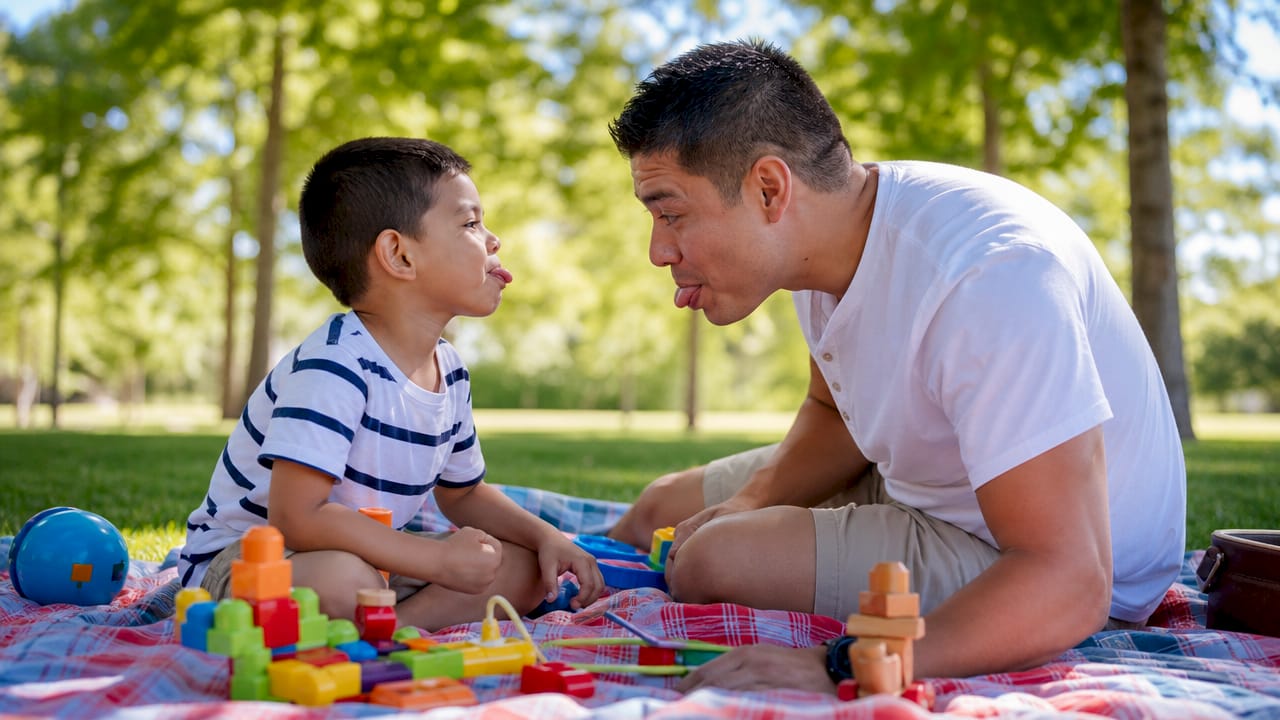 Father and child engaging in Floortime play therapy