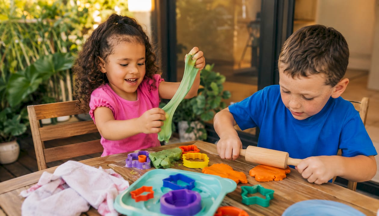 Children playing with slime and playdough materials