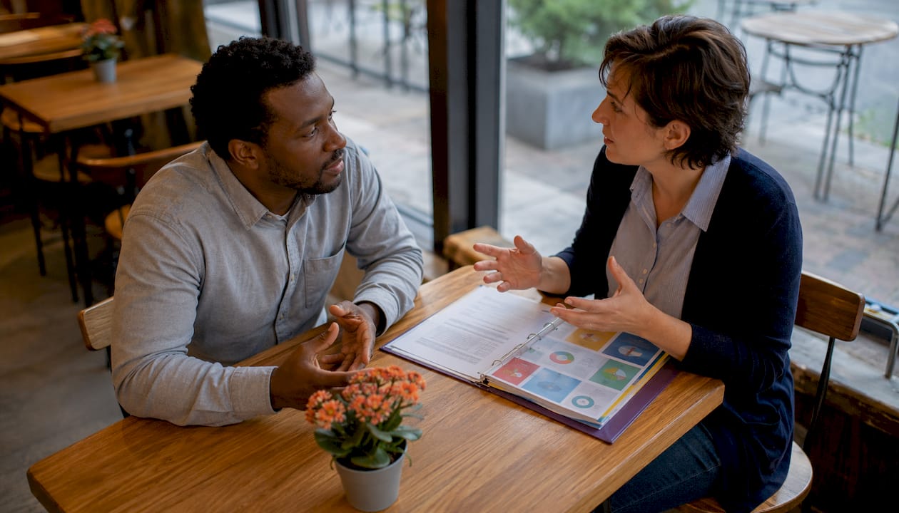 Man and social worker discussing autism support
