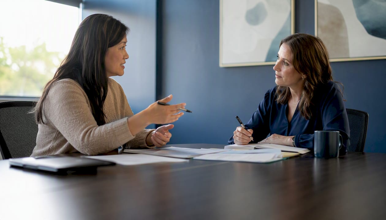 Parent and teacher discussing meeting goals