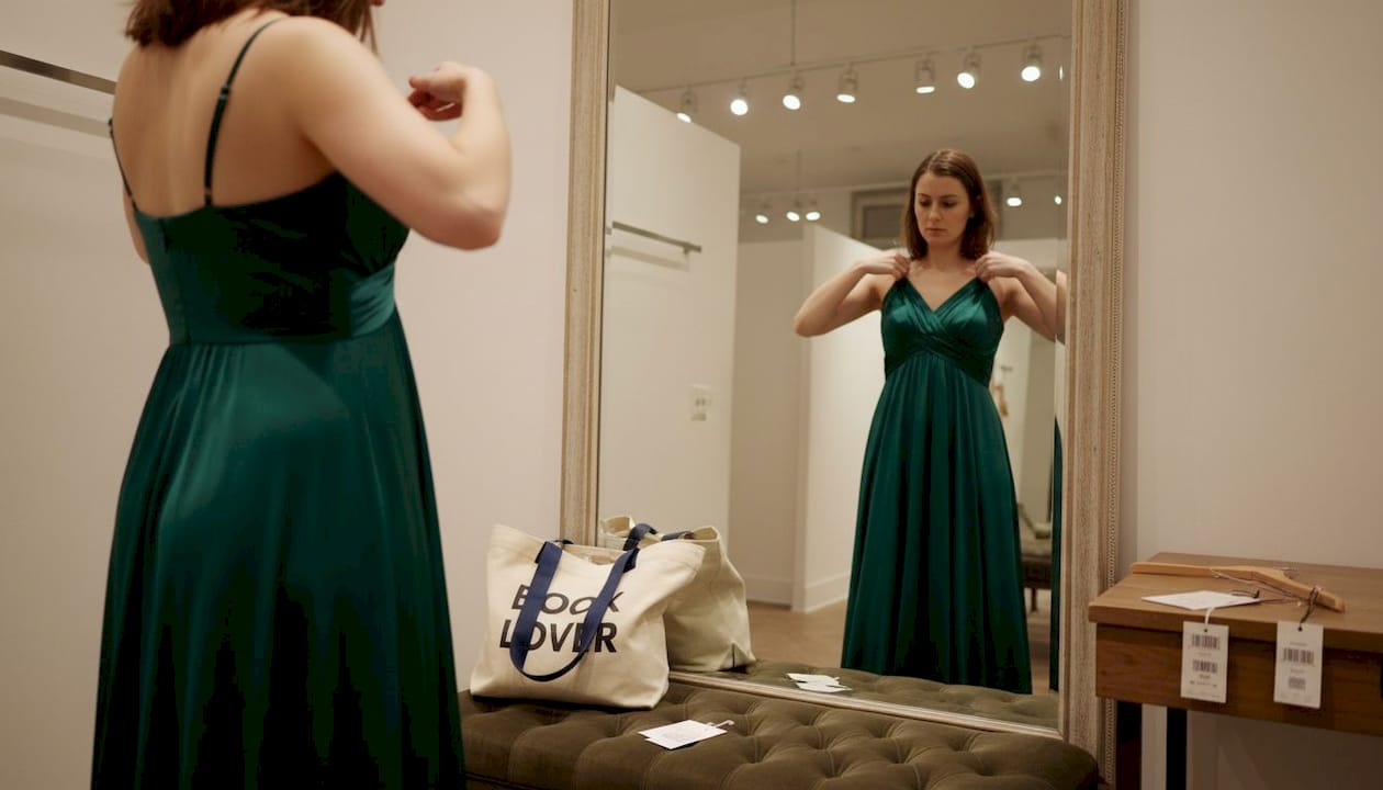 Woman trying on empire waist evening gown