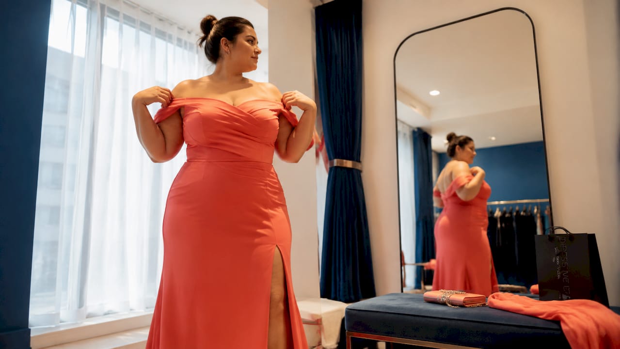 Plus size woman fitting pink lace dress