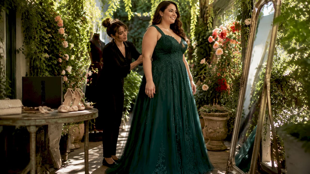Plus size woman fitting formal gown with stylist