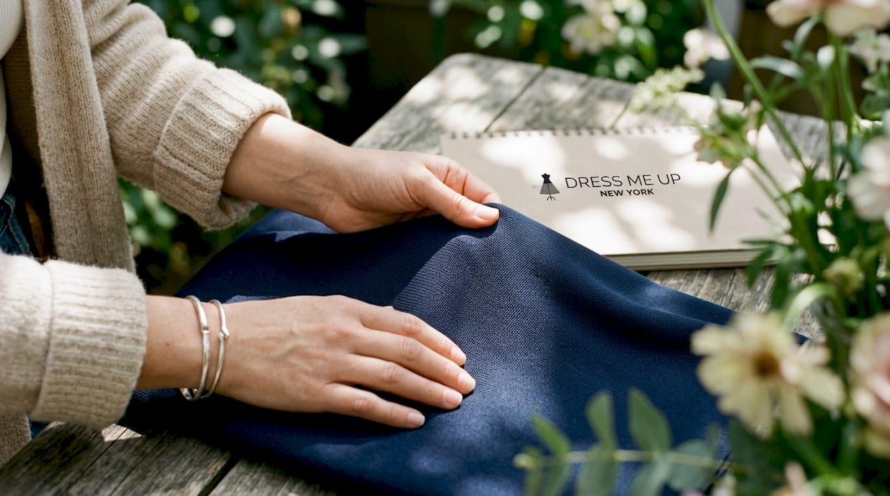 Close-up hands touching stretch-knit fabric