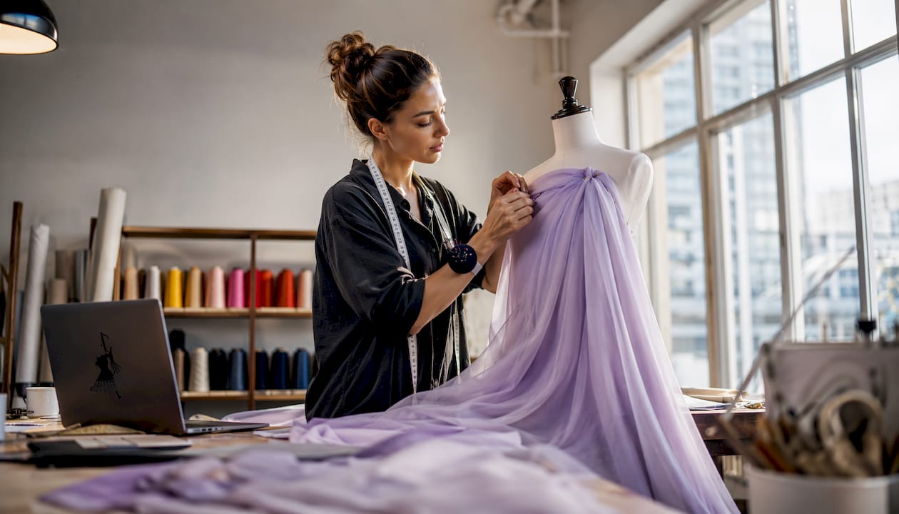Stylist working with lavender chiffon fabric