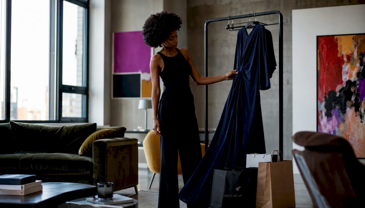 Woman browsing black tie evening gown in boutique