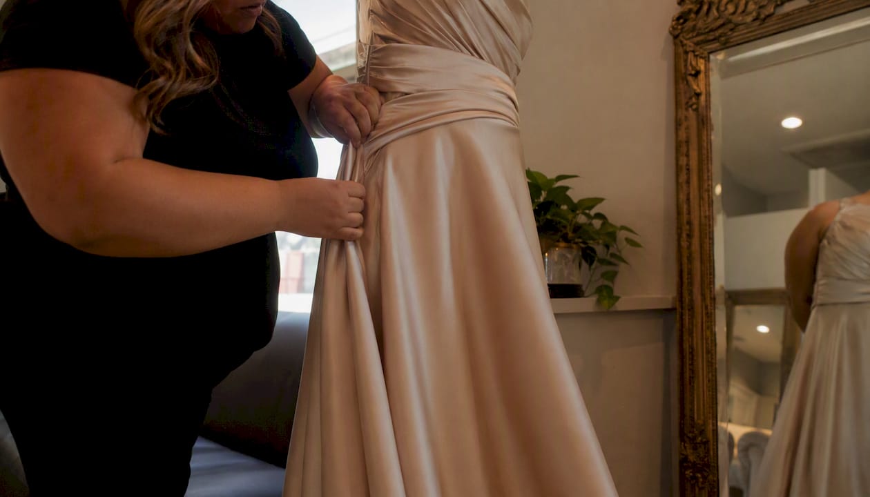 Plus size woman adjusting evening gown waist