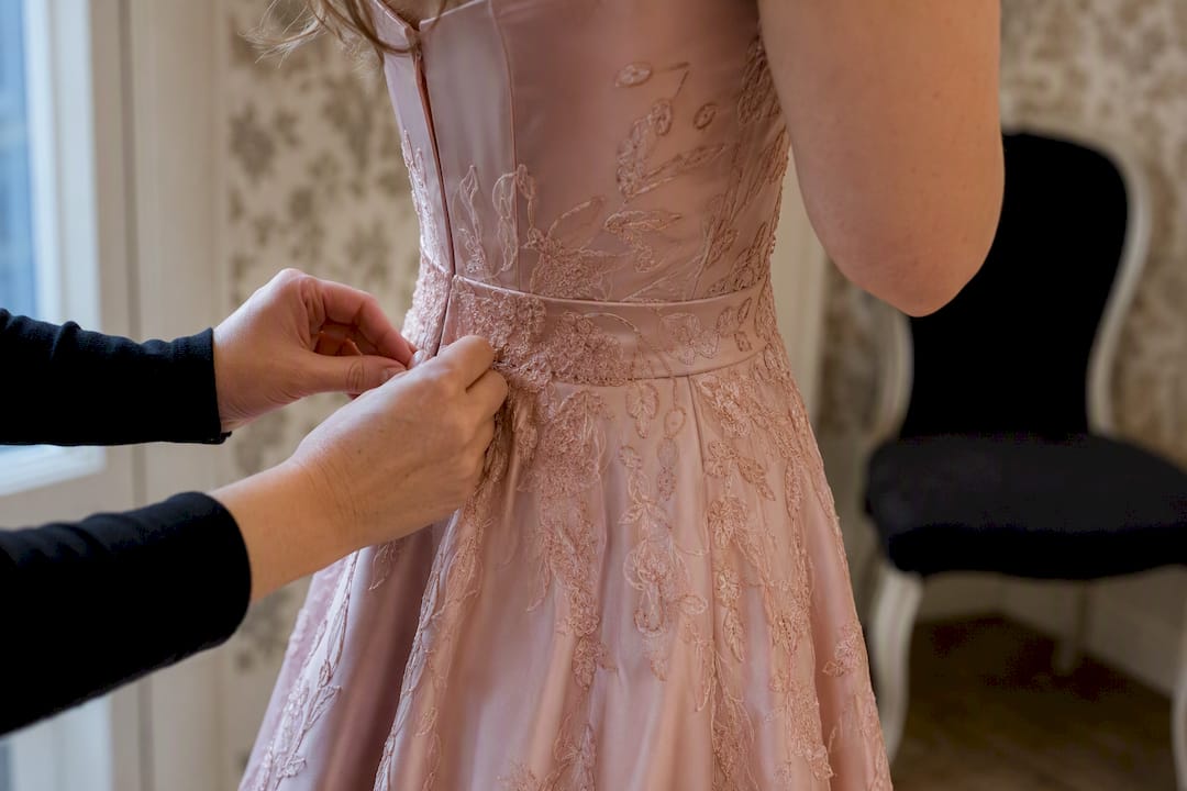 Hands touching fitted waist prom dress
