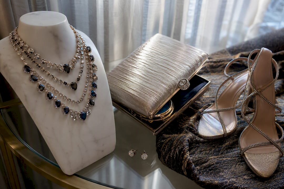 Jewelry necklace, clutch, and formal shoes close-up