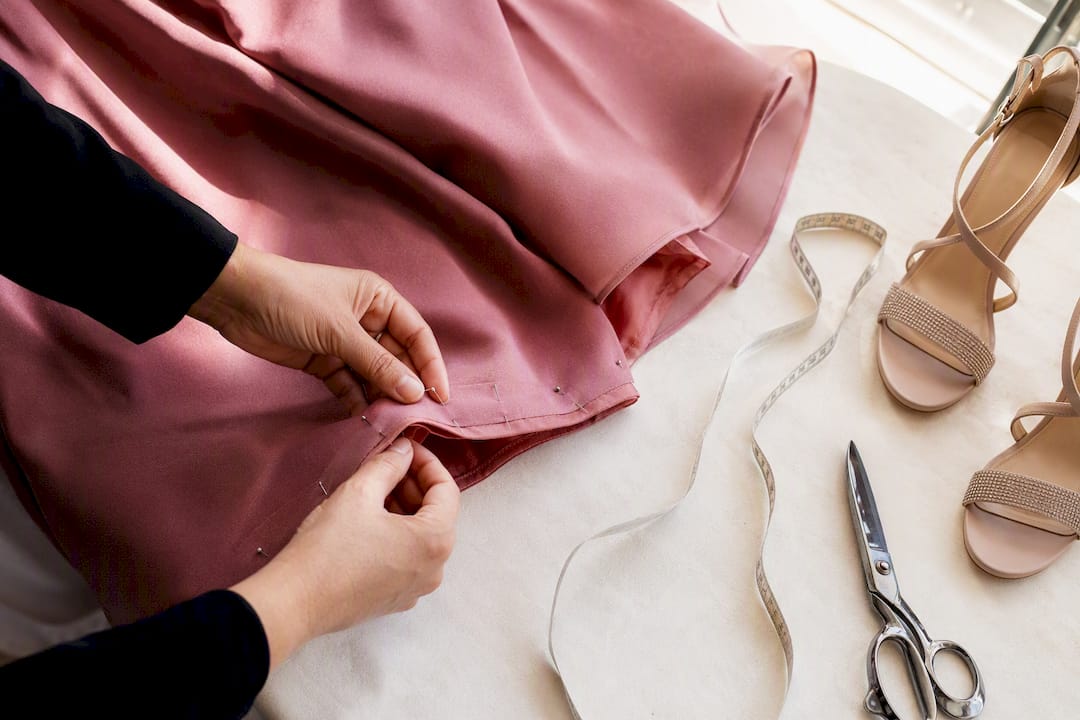 Tailor pinning formal gown hem