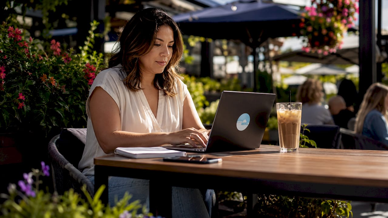 Woman networking online from coffee shop