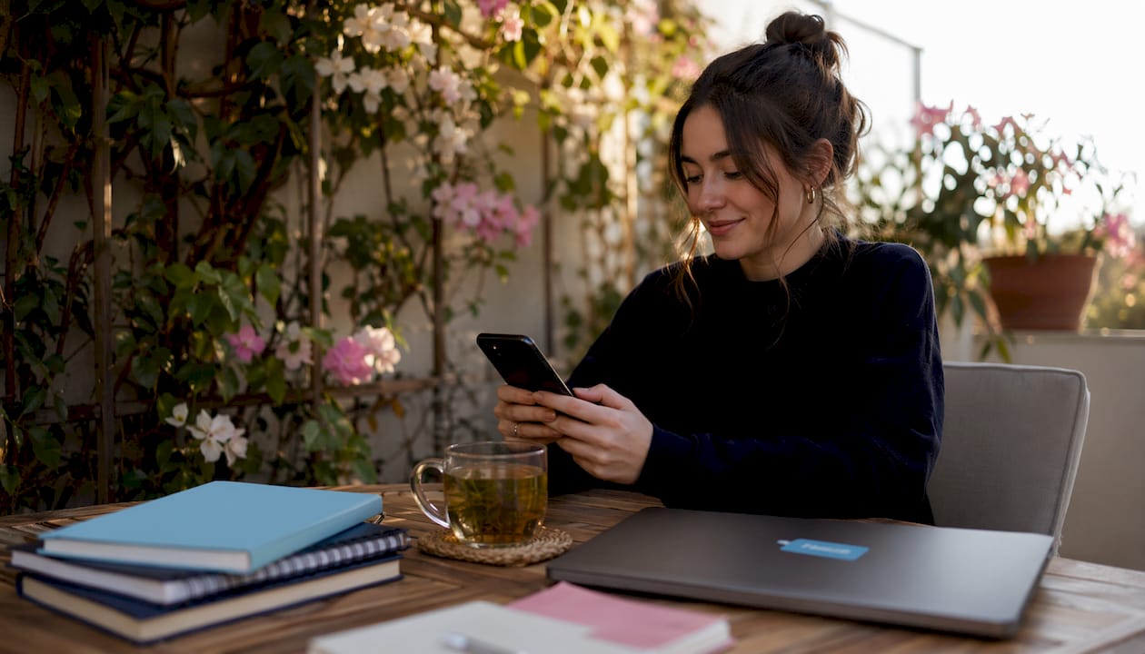 Woman using smartphone for social media at home