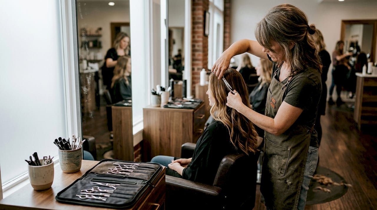 Stylist shaping long hair in creative session