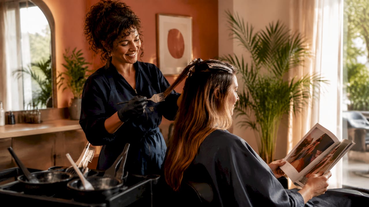 Stylist applying balayage at luxury salon