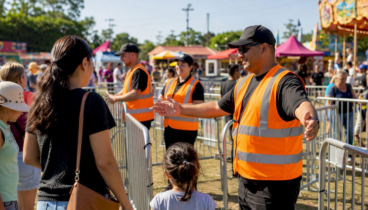 Event staff managing crowd control fencing layout