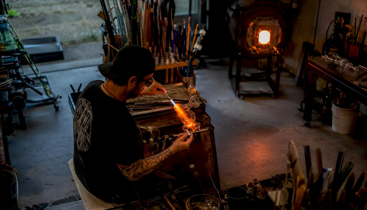 Glassblower working on borosilicate water pipe