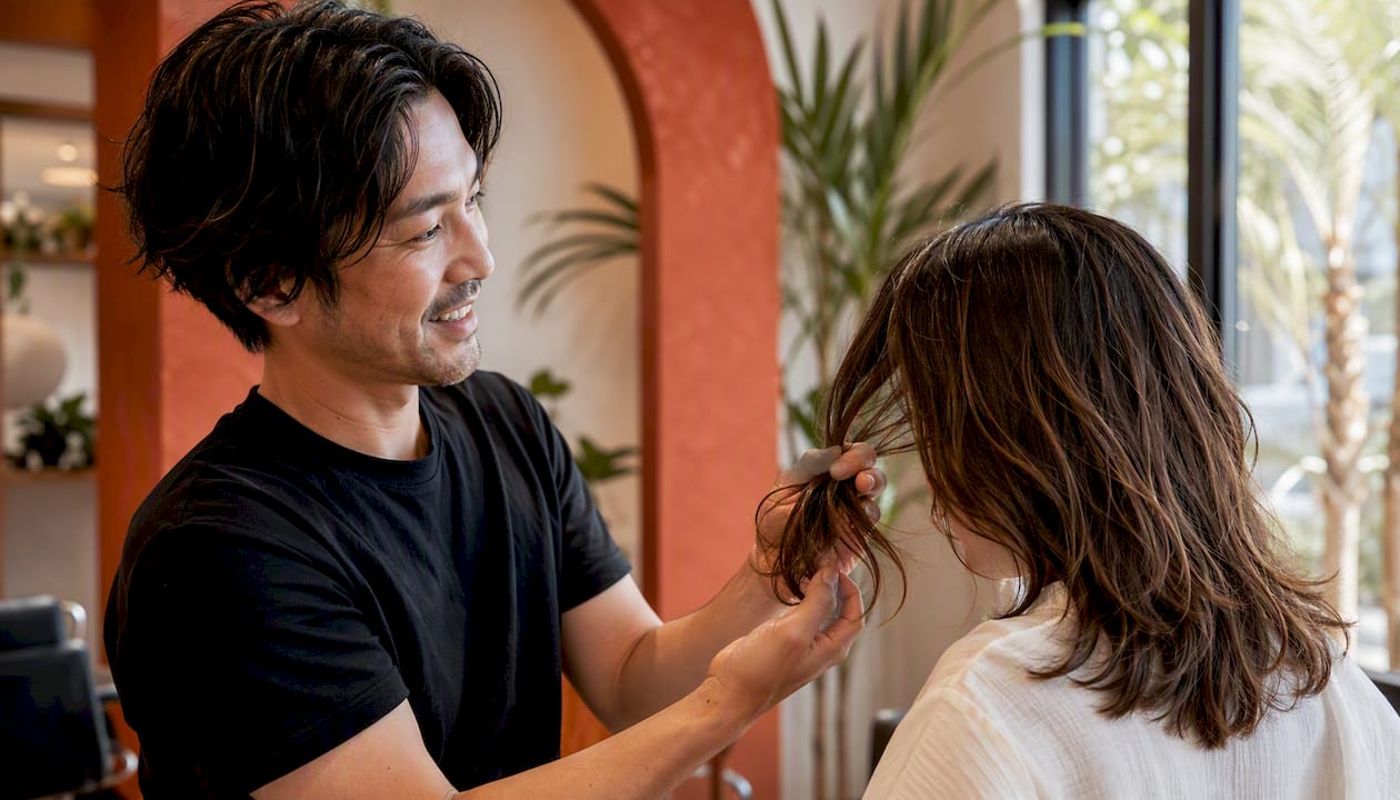 Stylist consulting client on hair design
