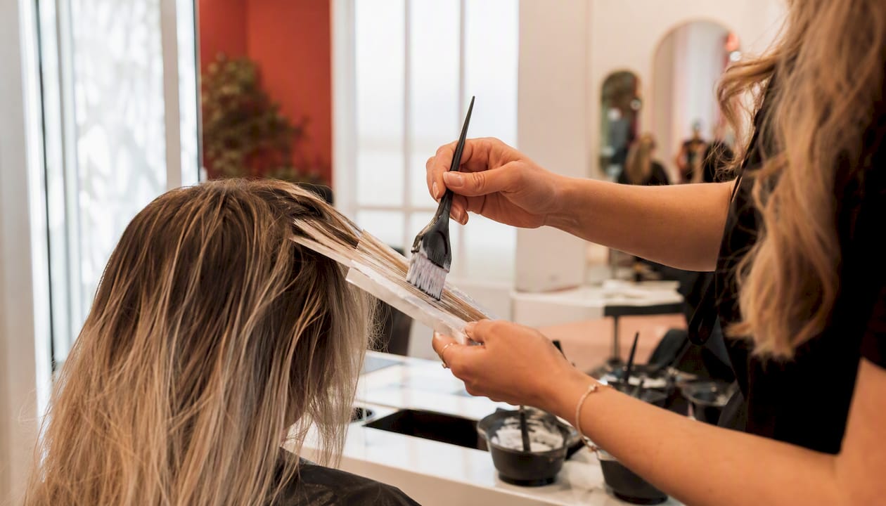 Stylist hand painting bespoke balayage highlights