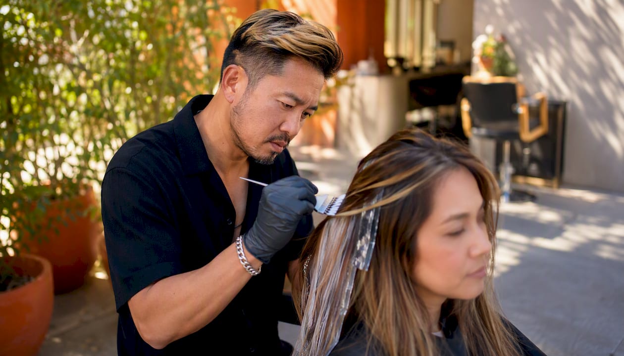 Stylist painting balayage in luxury salon