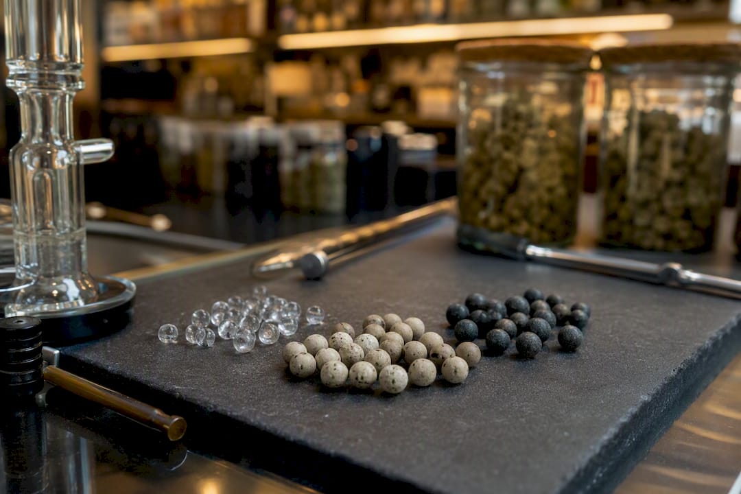 Terp pearls of varied materials on heat-safe surface