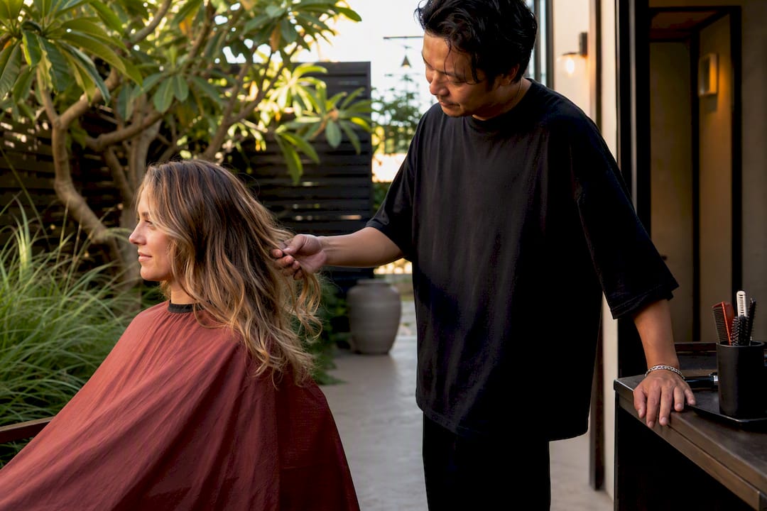Stylist consulting client hair condition in salon