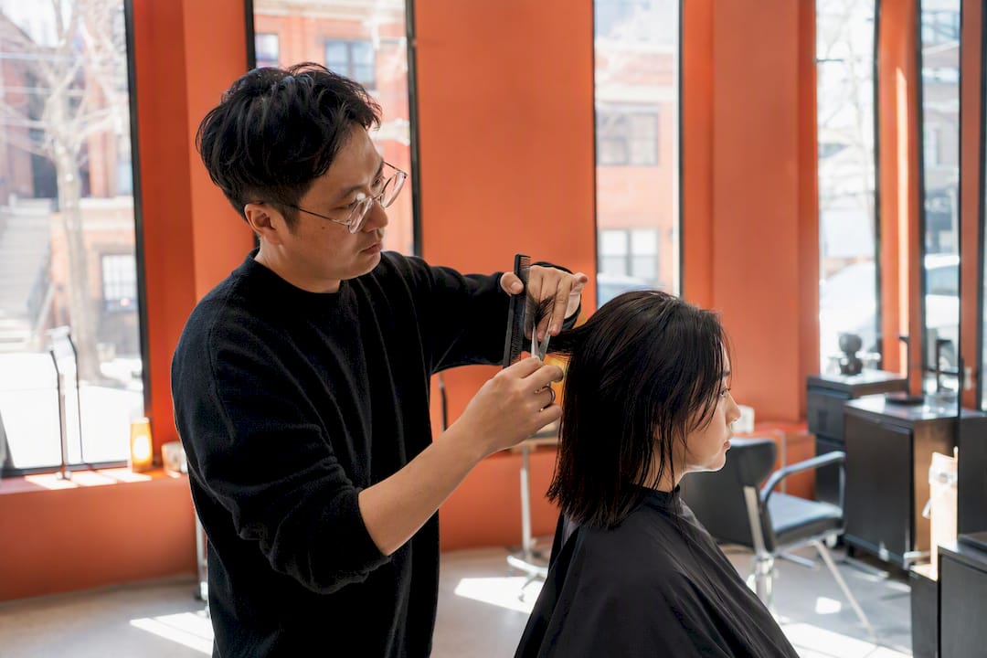 Stylist cutting hair at affordable NYC salon