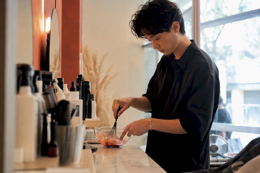 Stylist mixing hair color at workstation
