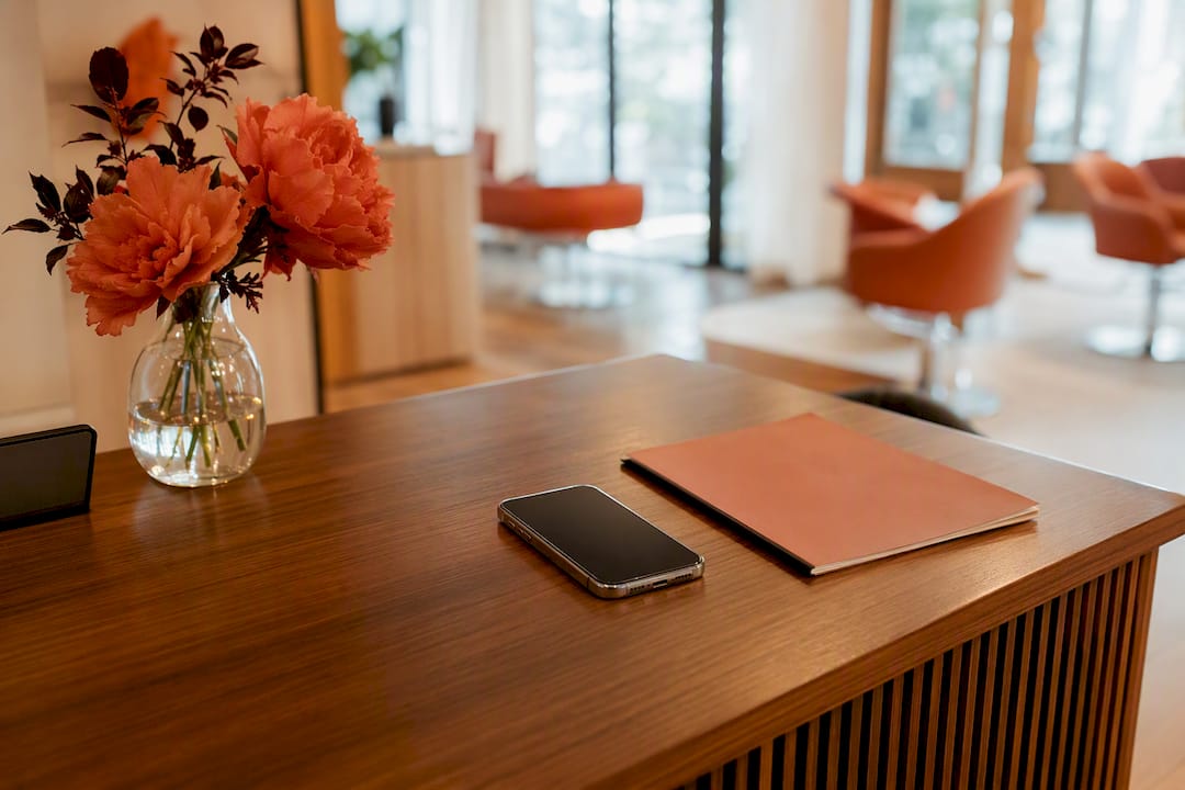 Smartphone and salon booking essentials on desk