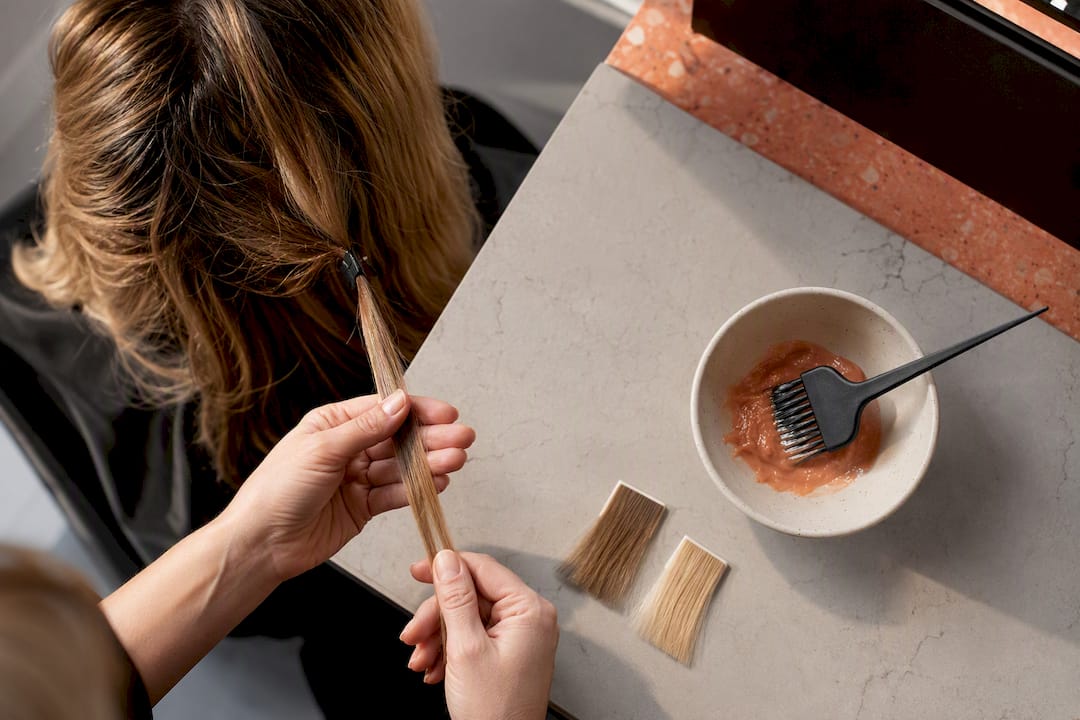 Stylist examining a hair color test strand