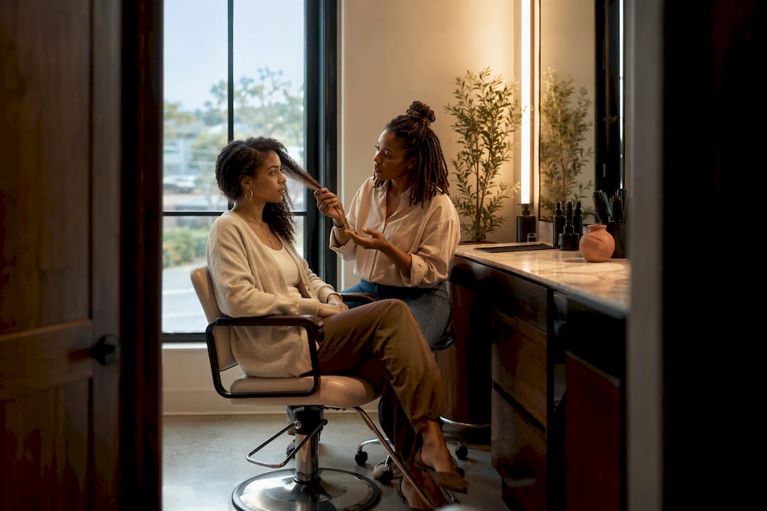 Client discussing hair goals with stylist