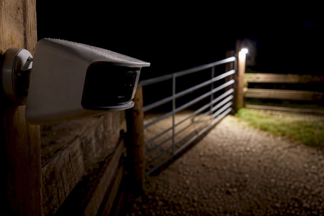Motion camera watching farm pen gate