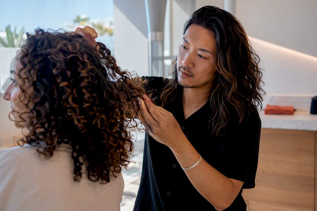 Specialist assessing curls during consultation