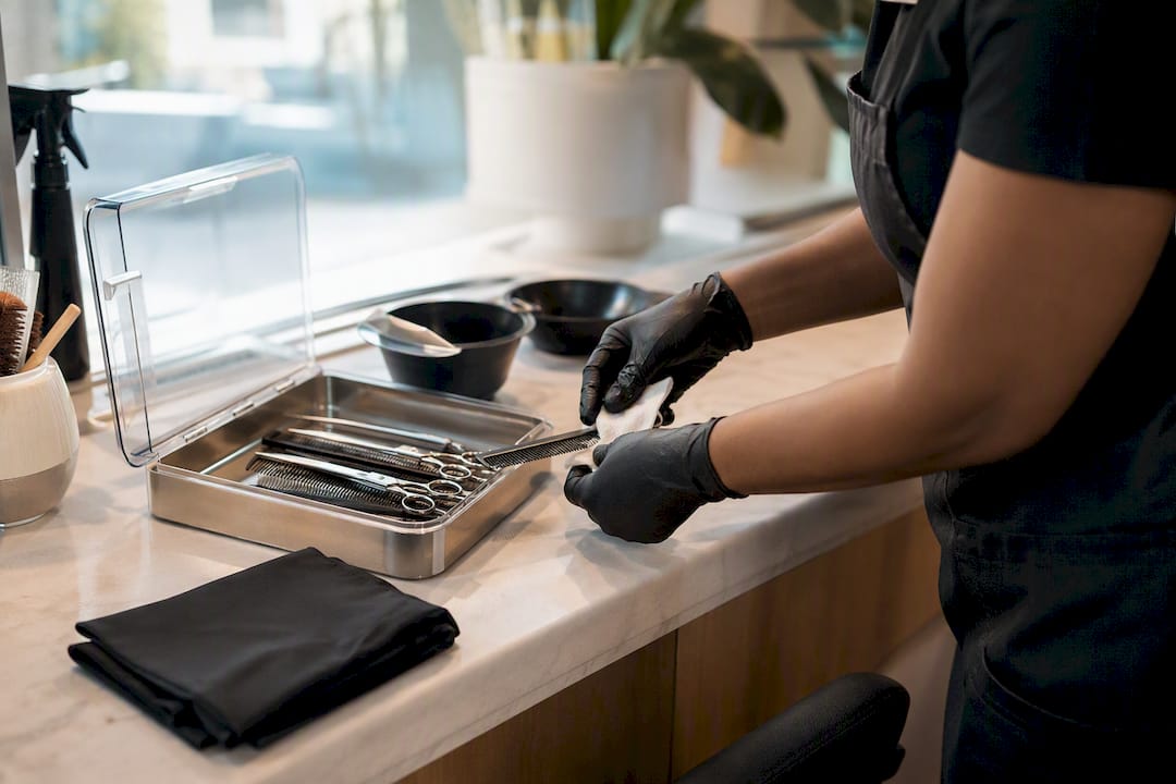 Stylist disinfecting salon tools between clients
