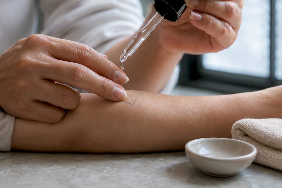 Hand applying topical CBD patch test