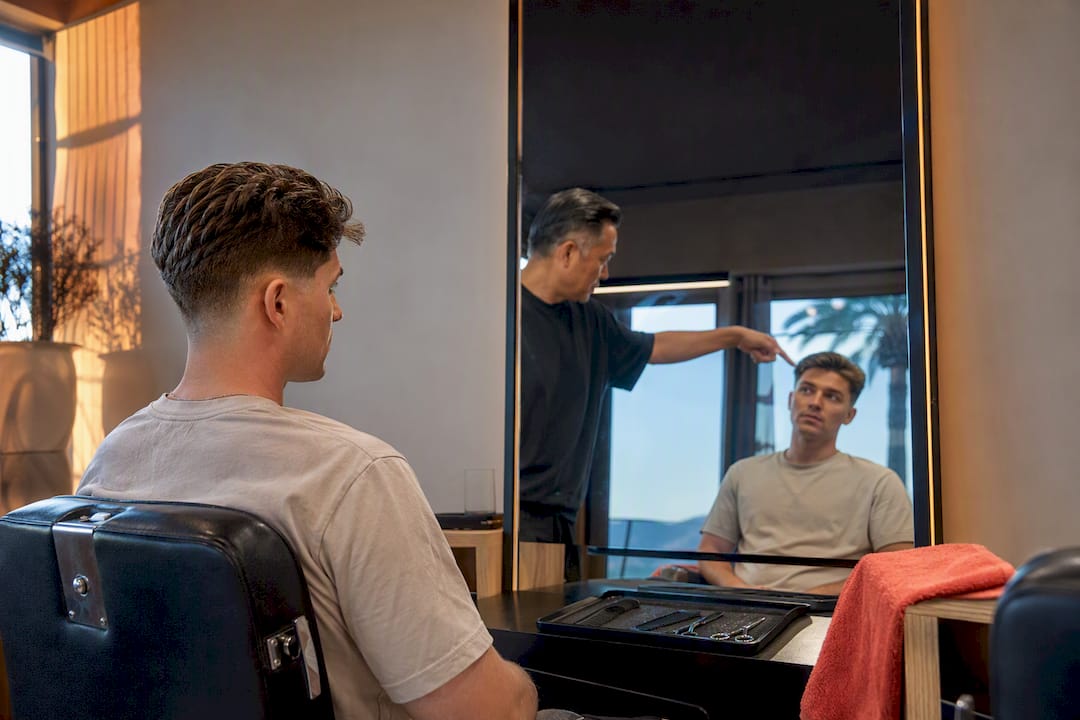 Hairdresser reviewing a men's haircut shape