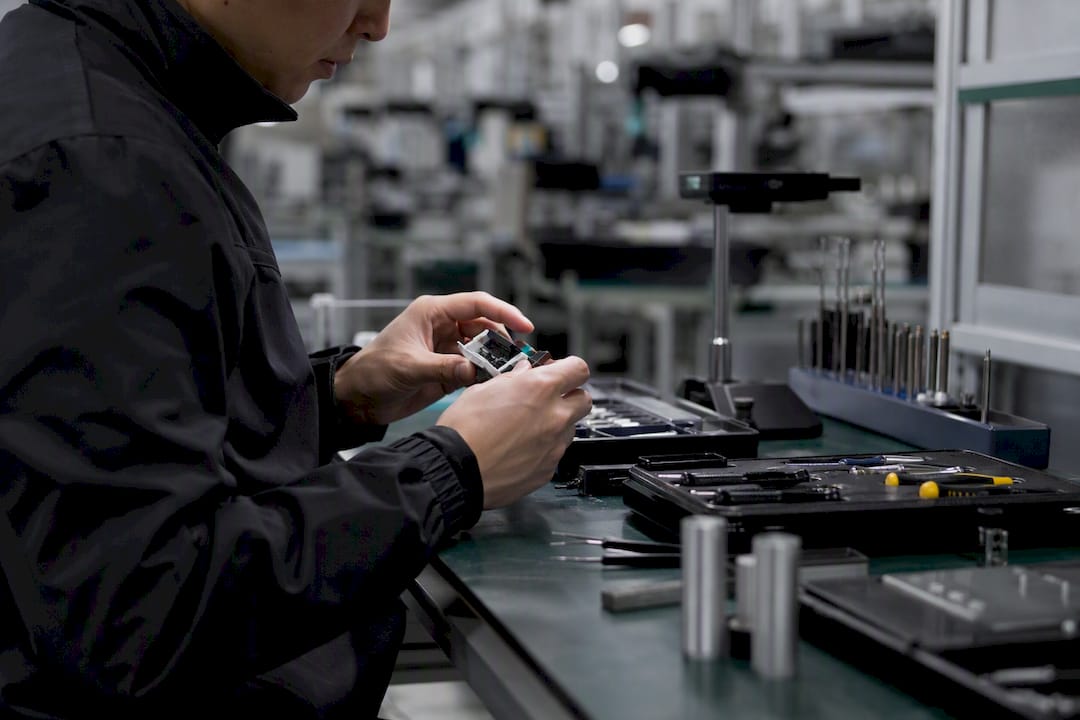 Hands performing manual product rework
