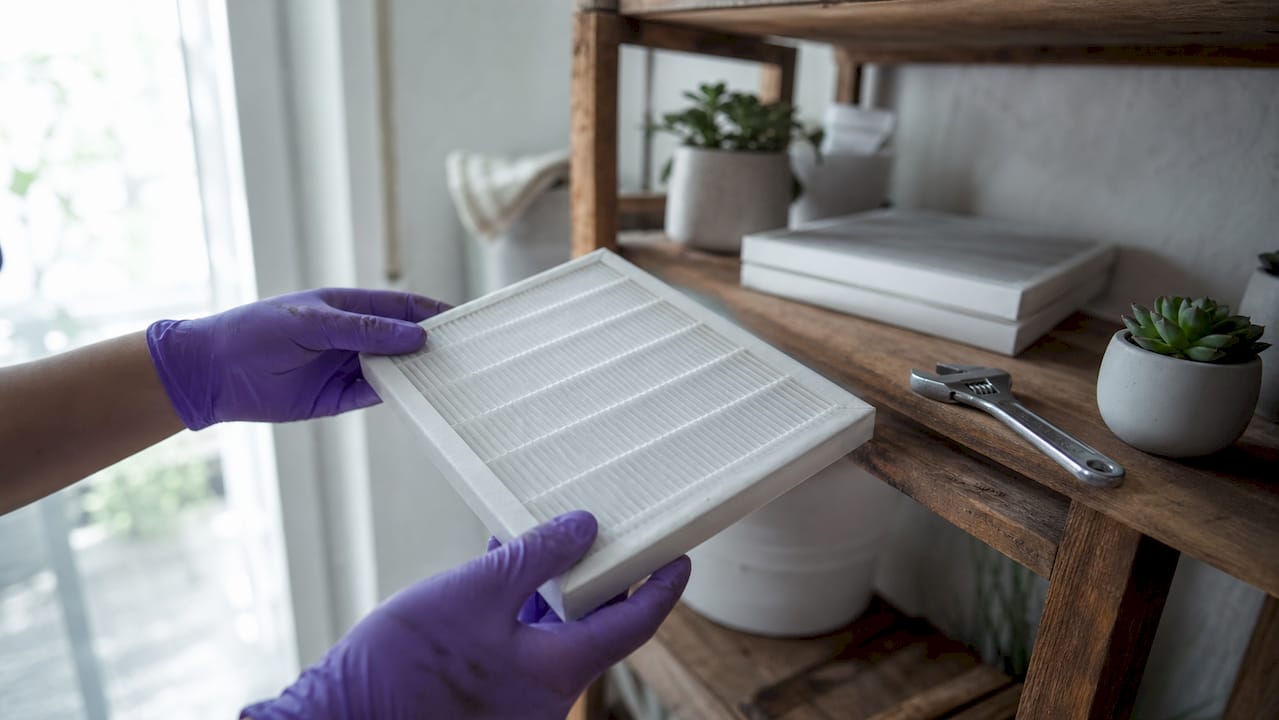 Hands holding clean HVAC air filter