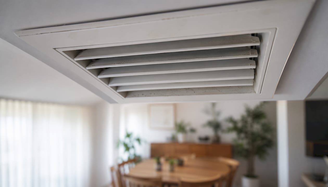 Close-up of white ceiling air diffuser vent