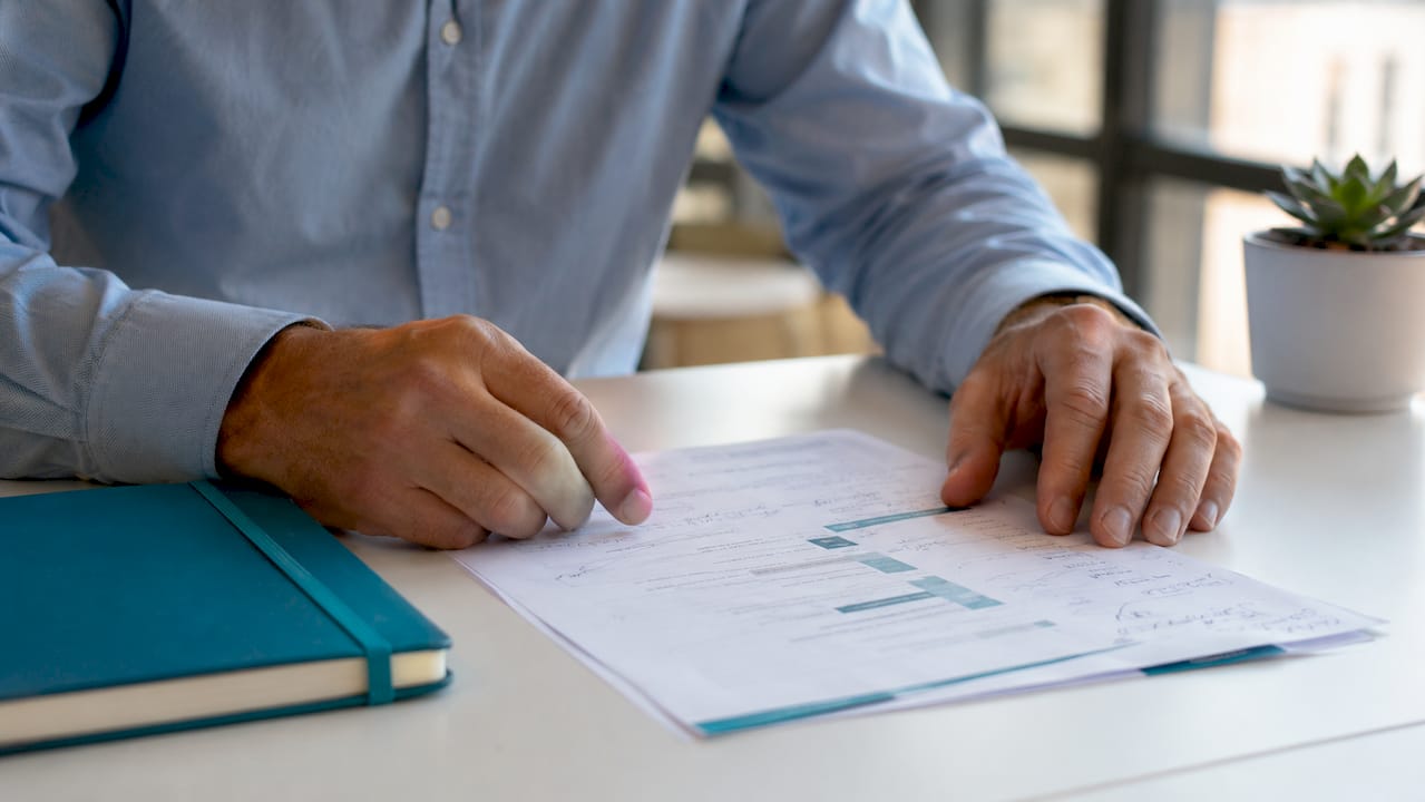Hands pointing at governance policy document